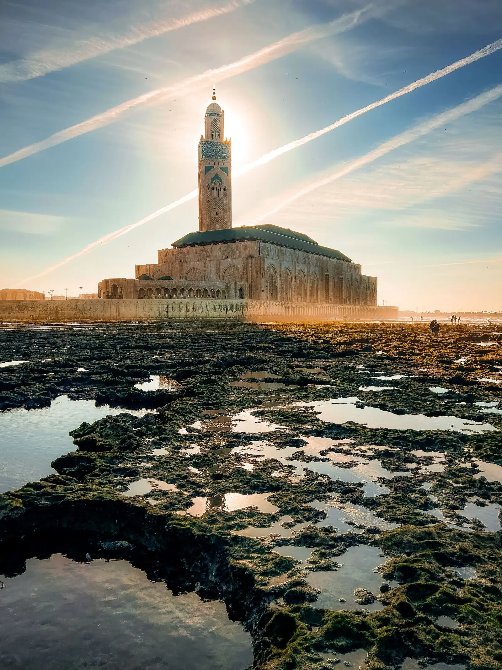 The Hassan II Mosque in Casablanca, photographed in warm sunrise light.